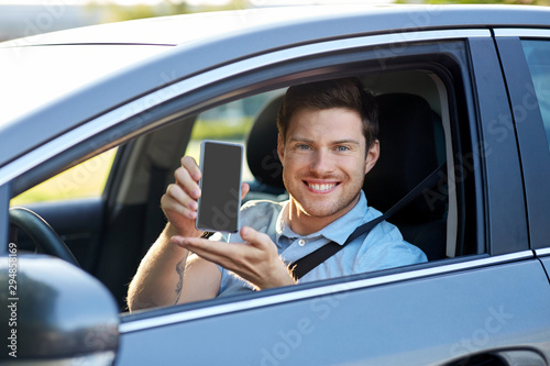 transport, driving and technology concept - man or car driver showing smartphone © Syda Productions