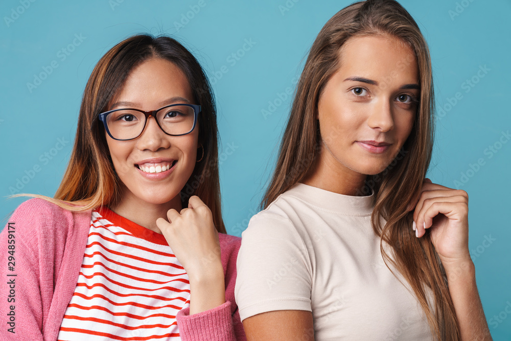 Portrait of multinational pretty women smiling and looking at camera Portrait of multinational pretty women smiling and looking at camera