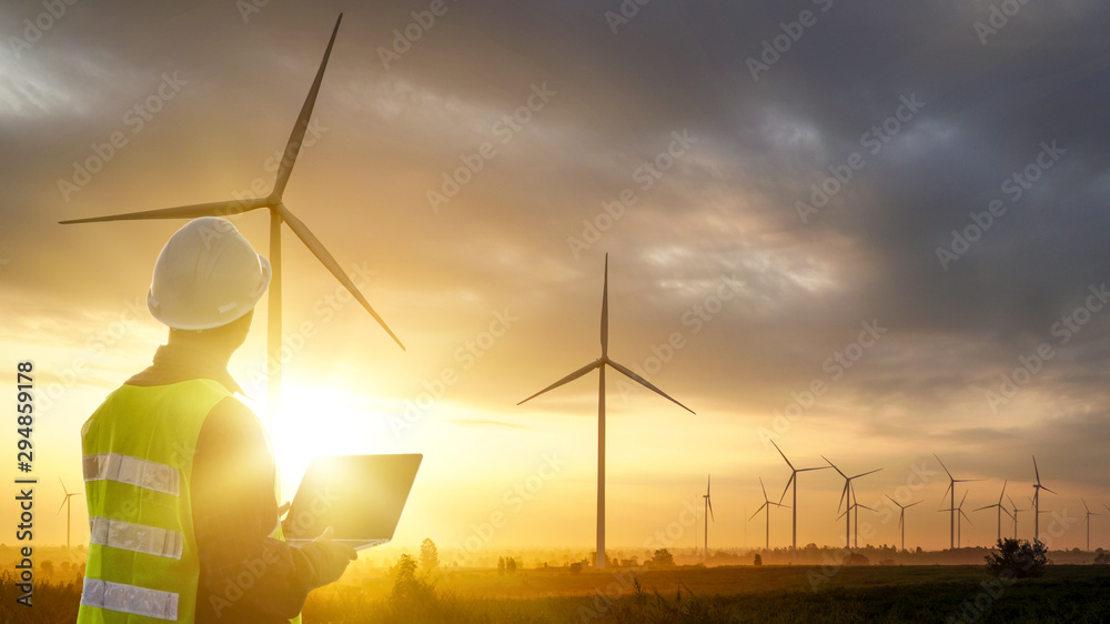 Silhouette of Technician Engineer  at wind turbine electricity industrial in sunset - obrazy, fototapety, plakaty 