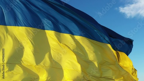 4k Ukrainian yellow blue flag, blue sky background, closeup, photo