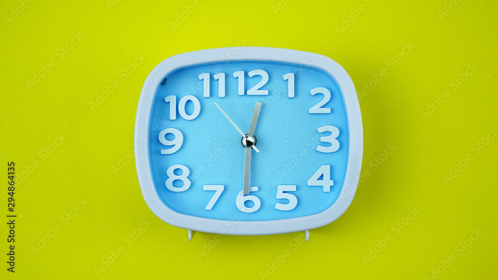 Blue Alarm clock on Yellow background, Copy space for your text, Time concept. Blue Alarm clock on Yellow background, Copy space for your text, Time concept.