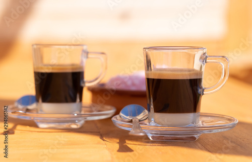 Close-up view of a couple of traditional spanish coffee made with condensed milk and espresso coffee. Focus on the most close cup