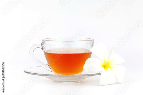 Cup of tea with plumeria flowers on white background