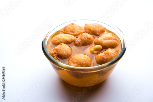 Kanji Vada / wada is a popular Rajasthani detoxifying dish consumed after over eating of sweets in Indian festival season. served in transparent Bowl or glass photo