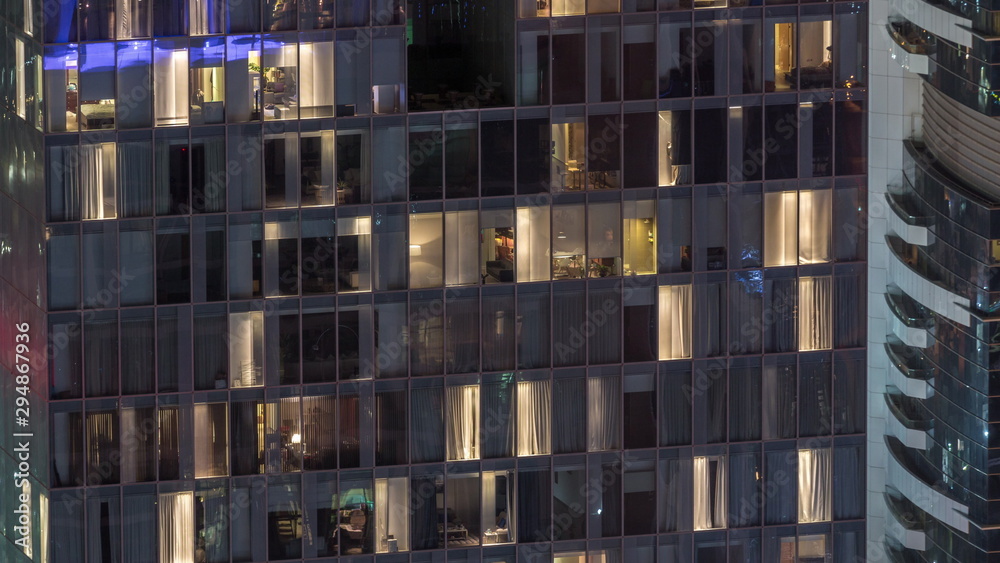 Night view of exterior apartment tower timelapse. High rise skyscraper with blinking lights in windows Night view of exterior apartment tower timelapse. High rise skyscraper with blinking lights in windows