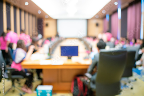 Abstract blurred people sitting in seminar conference hall room