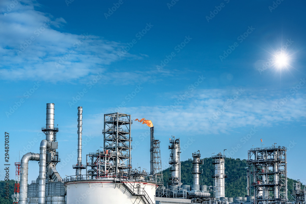 Fototapeta premium Close up Industrial view at oil refinery plant form industry zone with sunrise and cloudy sky