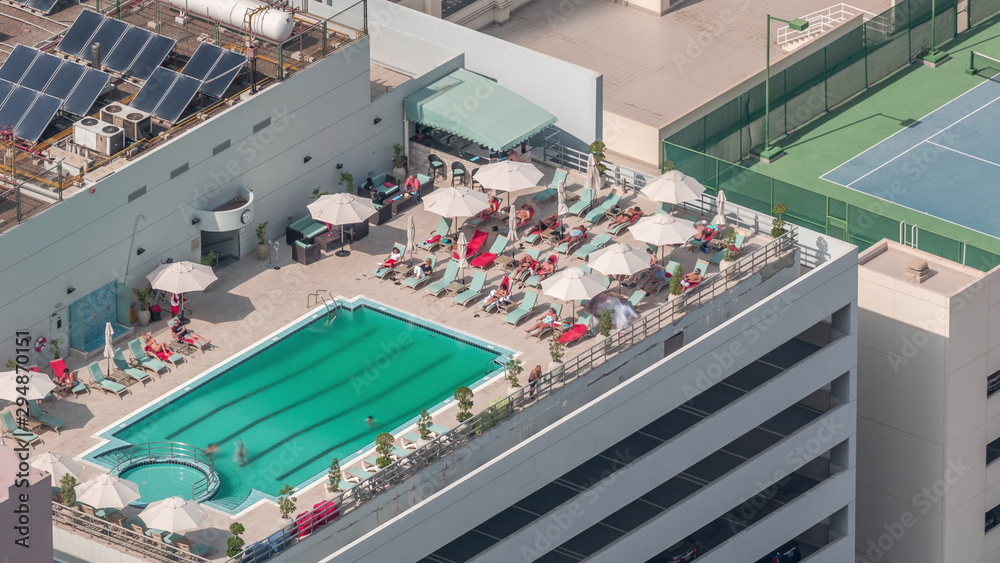 Car parking lot with rooftop swimming pool viewed from above timelapse, Aerial top view. Dubai, UAE Car parking lot with rooftop swimming pool viewed from above timelapse, Aerial top view. Dubai, UAE