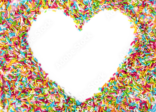 Heart shaped made from colored sprinkles. Heart shape with empty space for text in the centre of heart top view. Valentines Day background.