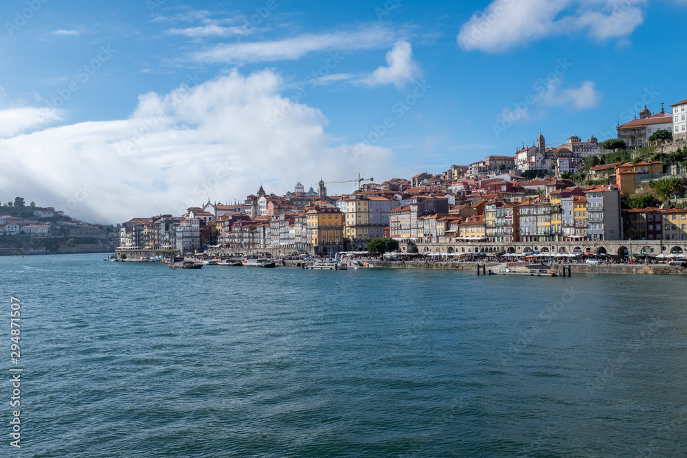 View of Porto across the Douro River from the opposite river bank with historic centre in the distance as the river snakes away