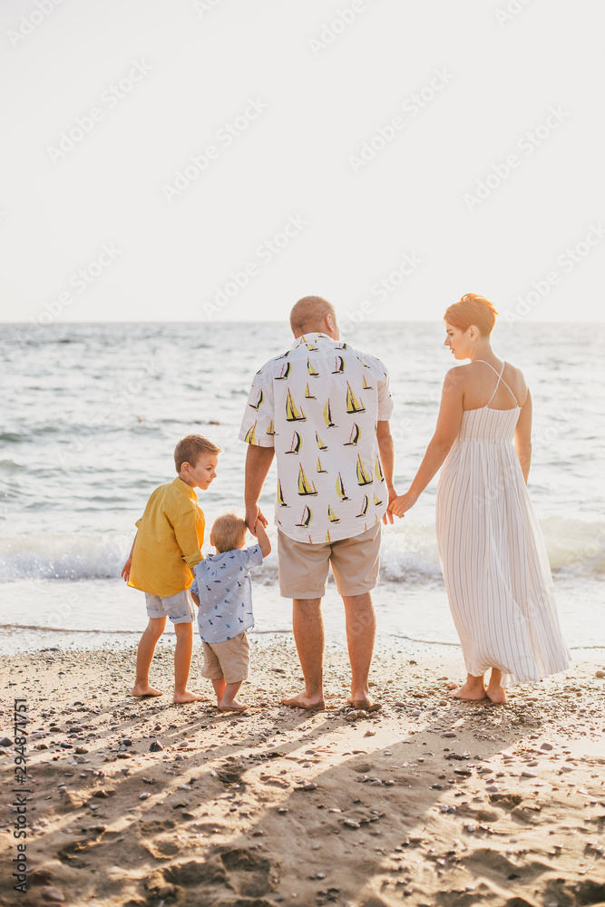 Happy family having fun on beach at sunset Happy family having fun on beach at sunset