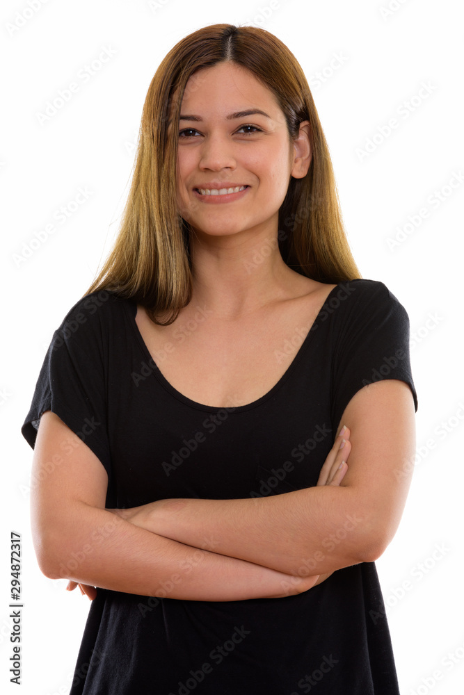 Studio shot of young happy woman smiling with arms crossed Studio shot of young happy woman smiling with arms crossed
