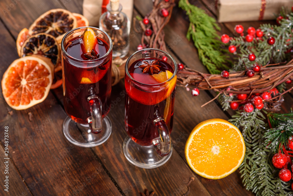 Christmas hot mulled wine with cinnamon cardamom and anise on wooden background Christmas hot mulled wine with cinnamon cardamom and anise on wooden background