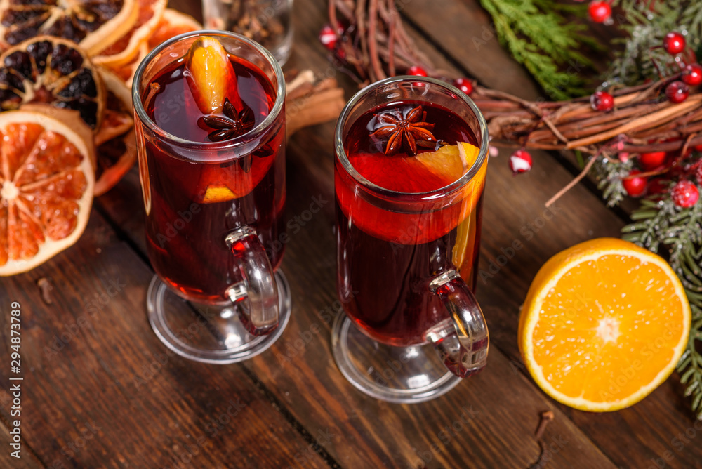 Christmas hot mulled wine with cinnamon cardamom and anise on wooden background