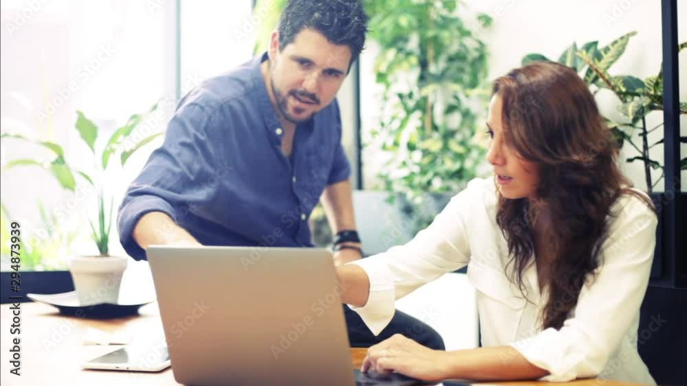 Young employees working together in a bright office. Coworking team meeting. Young employees working together in a bright office. Coworking team meeting.