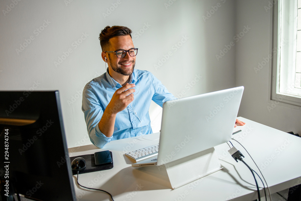 Young man having a conference call Young man having a conference call