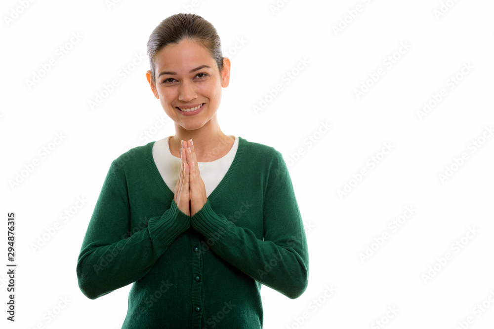 Studio shot of happy young beautiful woman smiling with hands to Studio shot of happy young beautiful woman smiling with hands to