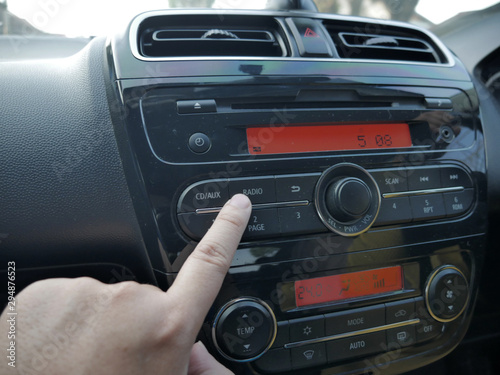 Driver's Hand Press Button on Car Radio
