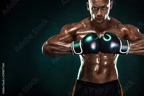 Sportsman, man boxer fighting in gloves on black background. Fitness and boxing concept. Individual sports recreation.