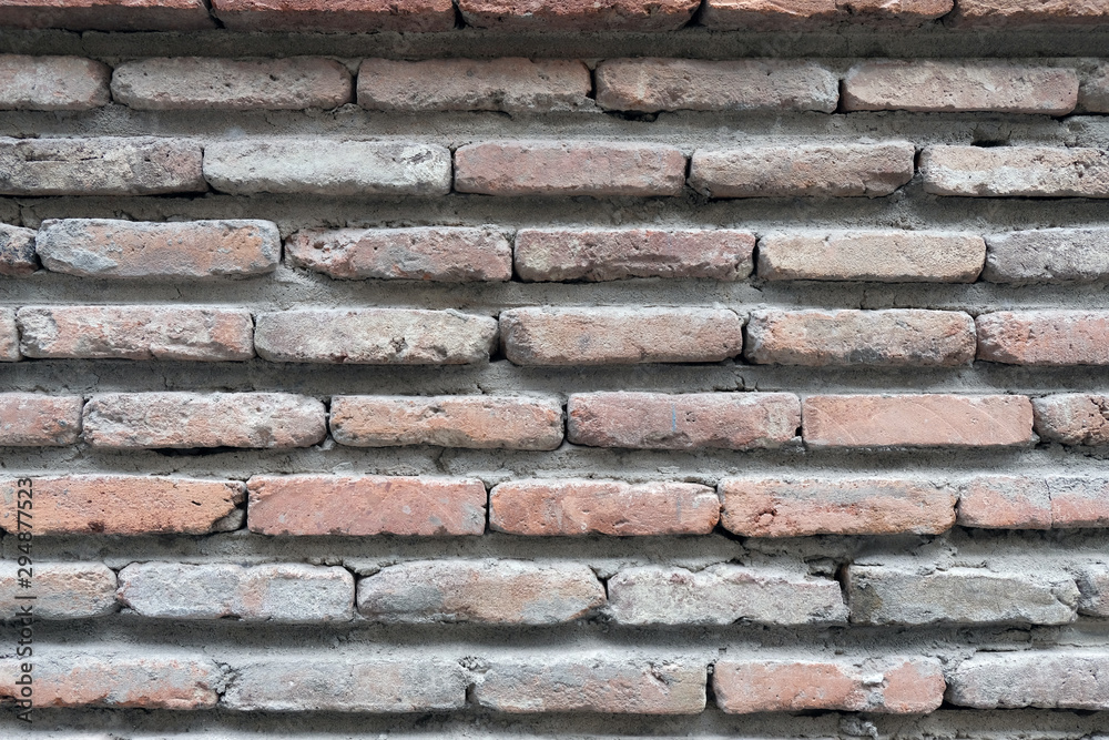 Old brick wall of brown color. Bricks pushed forward the background. Old brick wall of brown color. Bricks pushed forward the background.