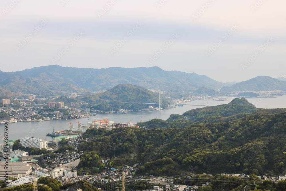 Landscape view of top Mount Inasa in sunny day with Nagasaki city and blue sky and mountain