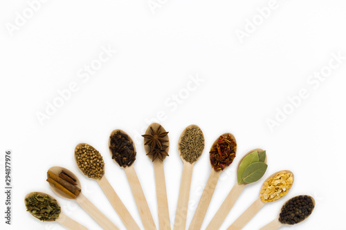 composition of assorted spices in wooden spoons on a white background. top view. flat lay. with copy spise