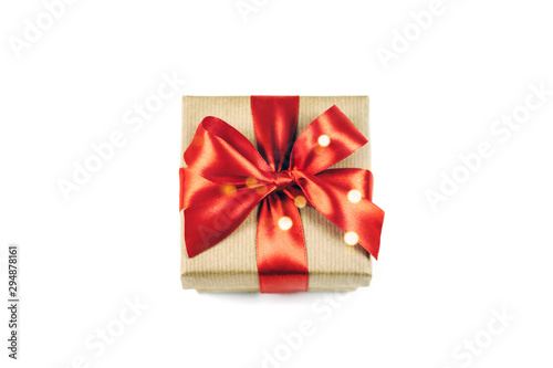 Festive gift box with red ribbon bow isolated on white.