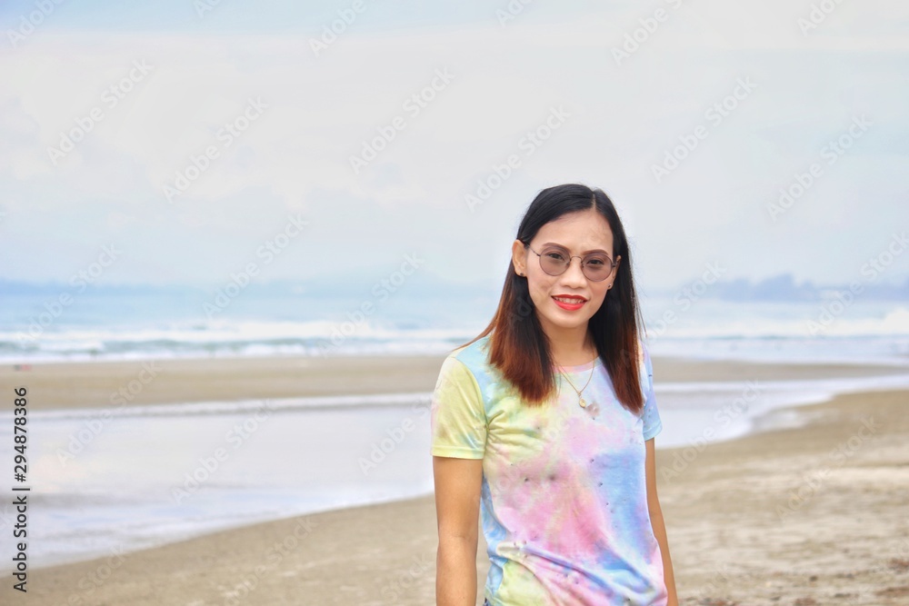 asian woman stand on the beach with blurred background asian woman stand on the beach with blurred background