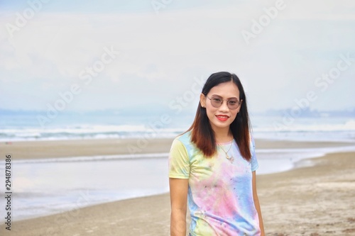 asian woman stand on the beach with blurred background