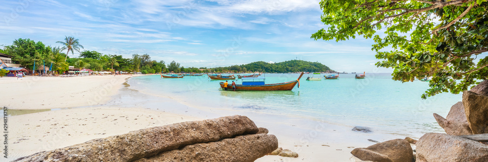 Panorama of Koh Lipe Sunset Beach with water on foreground
