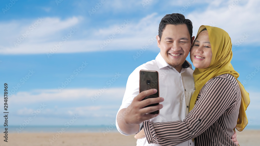 Muslim Couple on The Beach. Halal Tourism Concept