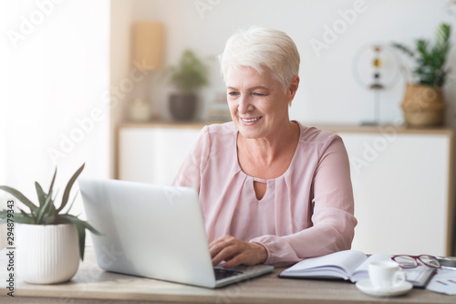 Mature business lady enjoying her job, working from home
