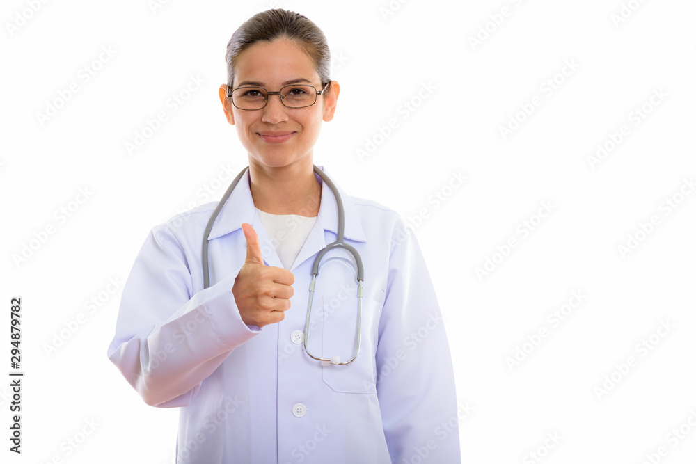 Studio shot of young beautiful woman doctor giving thumb up Studio shot of young beautiful woman doctor giving thumb up