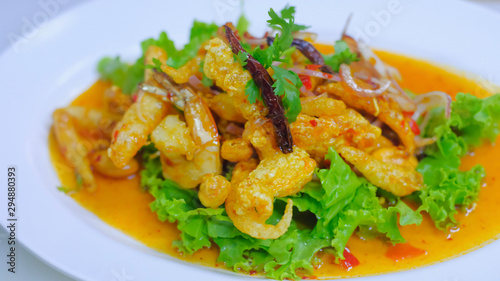 Close up Crispy Fish Maw in Spicy Salad with vegetable on white dish, thai food.