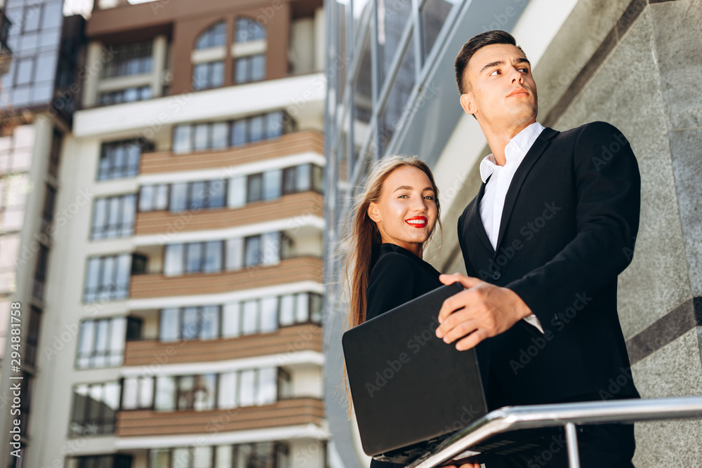 Man and happy woman as business partners in the business district.- Image. Man and happy woman as business partners in the business district.- Image.