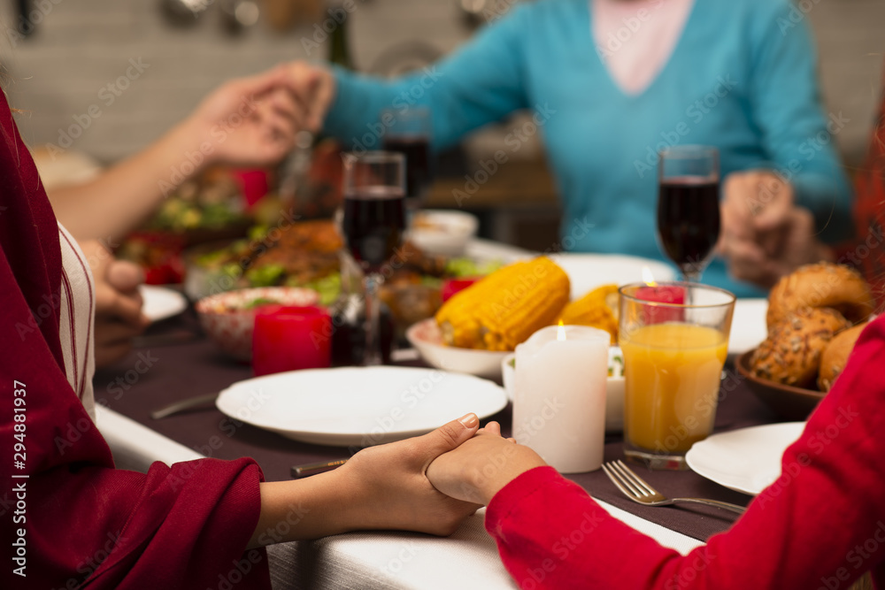 Family holding hands on thanksgiving event