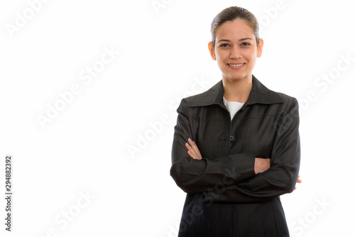 Studio shot of young happy businesswoman smiling with arms cross