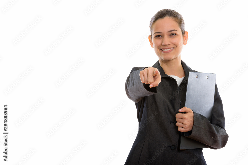 Studio shot of young happy businesswoman smiling holding clipboa Studio shot of young happy businesswoman smiling holding clipboa