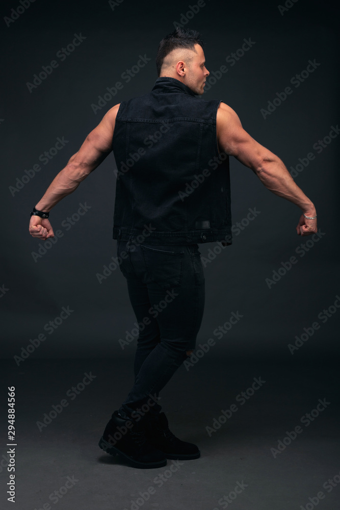 Strong and handsome young man with muscles and biceps. Studio shooting on black background. Strong and handsome young man with muscles and biceps. Studio shooting on black background.