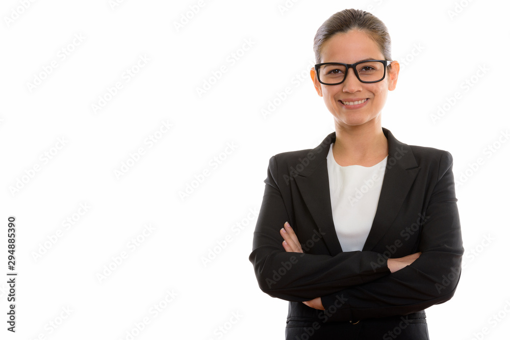 Studio shot of young happy businesswoman smiling while wearing e Studio shot of young happy businesswoman smiling while wearing e