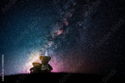Couple love teddy bear (non branded) hugging on starry night sky, love concept 