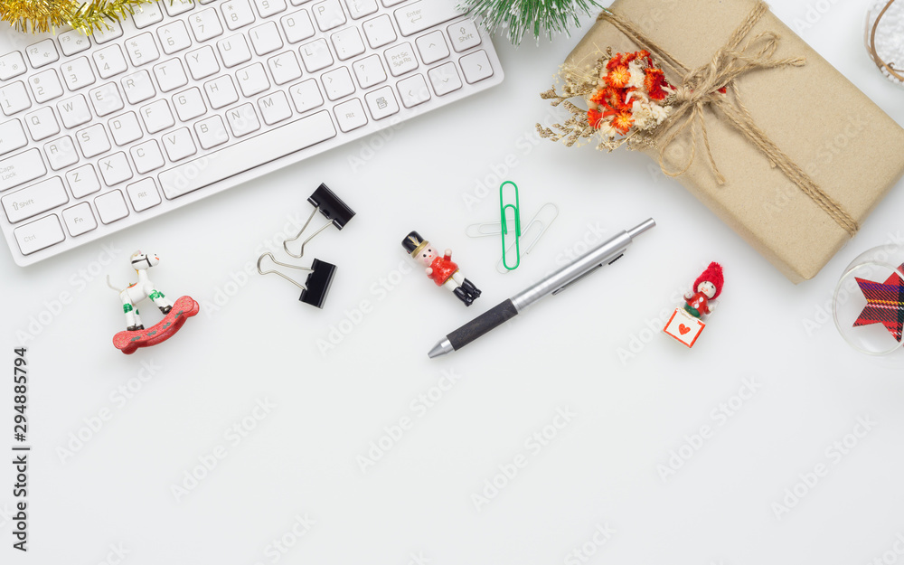 Merry Christmas and Happy new years office work space desktop concept. Flat lay top view with keyboard, gift box and Christmas ornaments with copy space. Merry Christmas and Happy new years office work space desktop concept. Flat lay top view with keyboard, gift box and Christmas ornaments with copy space.