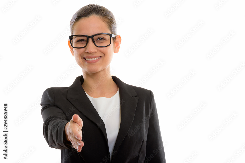 Studio shot of young happy businesswoman smiling while giving ha Studio shot of young happy businesswoman smiling while giving ha