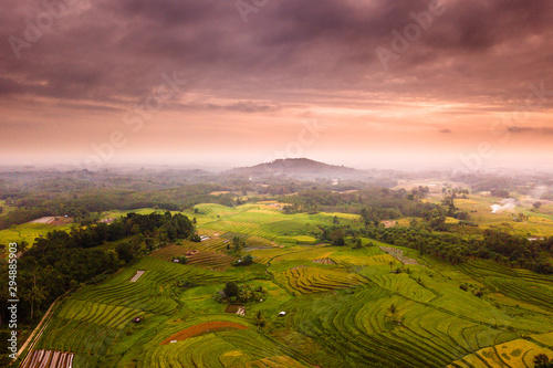 Indonesian natural beauty with aerial photography at sunrise on the mountains in yellow and green with beautiful sky on moment