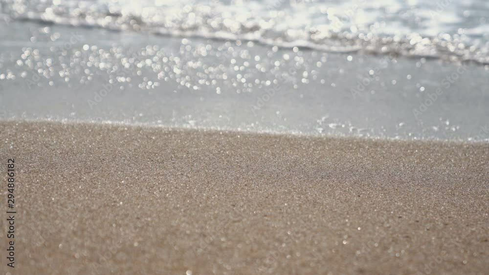 View of a sand beach sea with a clear water on sun light in the summer. 4K UHD, Video Clip.