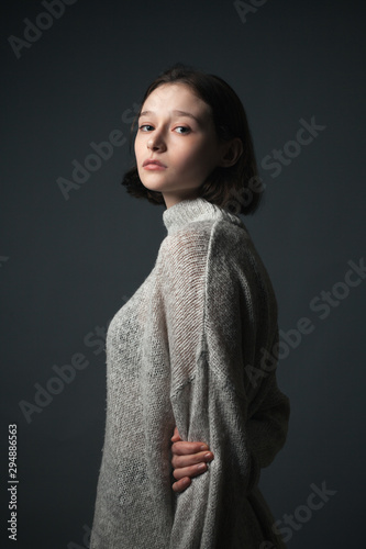 Portrait of beautiful thin young woman in sweater. © Dima Aslanian