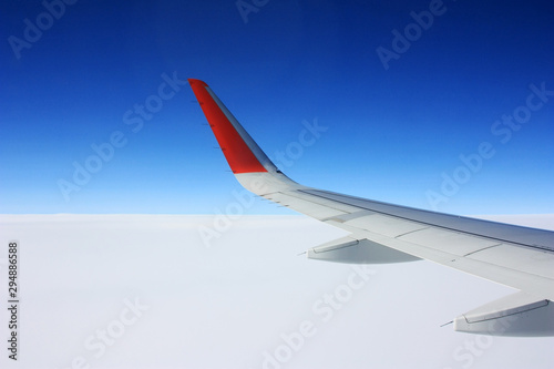Airplane wing in blue sky