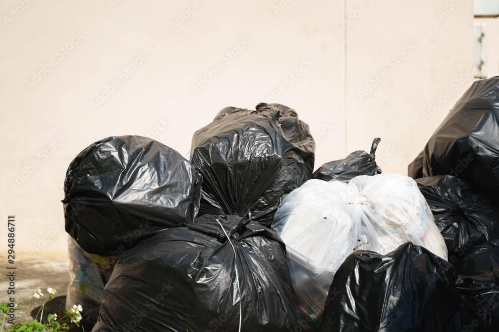 pile black garbage bag plastic and four dustbin dirty roadside in the city  with copy space add text Stock Photo - Alamy