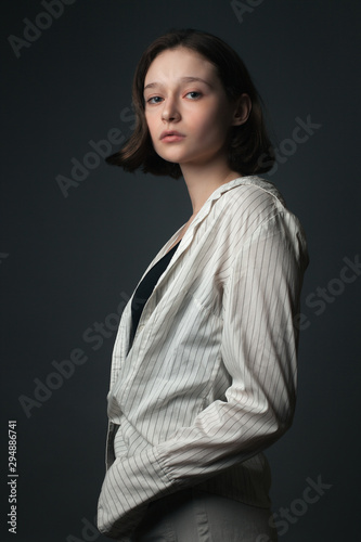 Young beautiful woman in shirt posing in studio. © Dima Aslanian