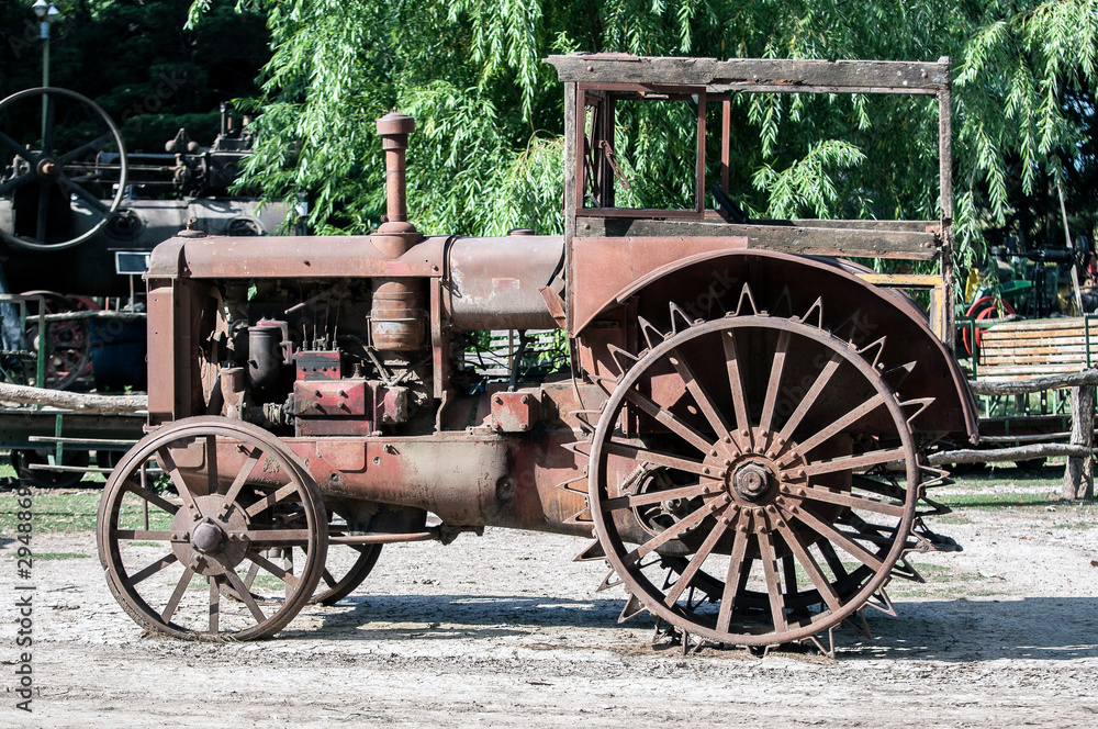 Close up view of an old, rusty, abandoned tractor.